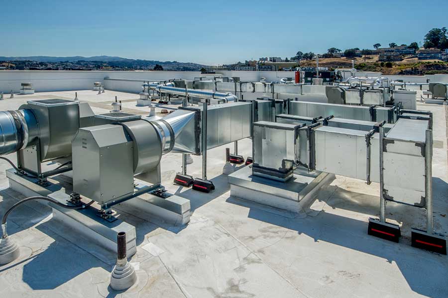 Commercial rooftop with HVAC ductwork and ventilation units for repair service