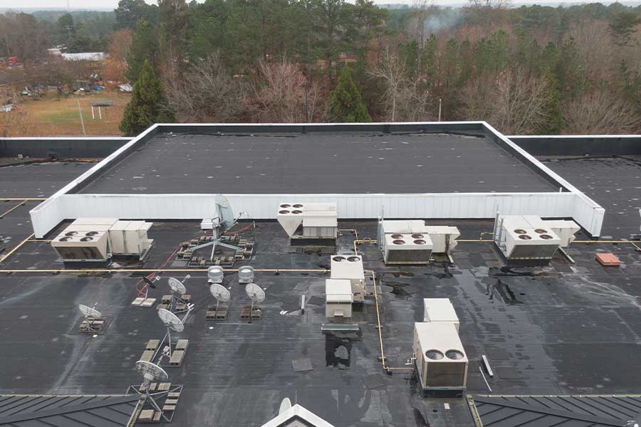 Large commercial roof with HVAC systems set up for repair and service