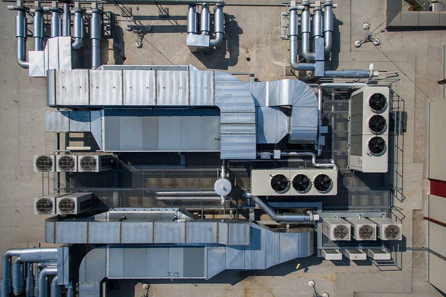 Rooftop commercial HVAC system with large ductwork and condenser units during repair in Skokie, IL